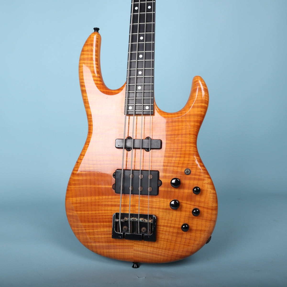 Front view of the Carvin LB70 bass body featuring a flame maple top in amber finish.