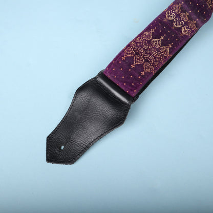 Close-up of the black leather end tab and gold-printed purple velvet strap