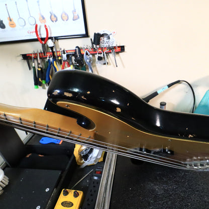 Edge view of the upper bout and forearm contour on the workbench.