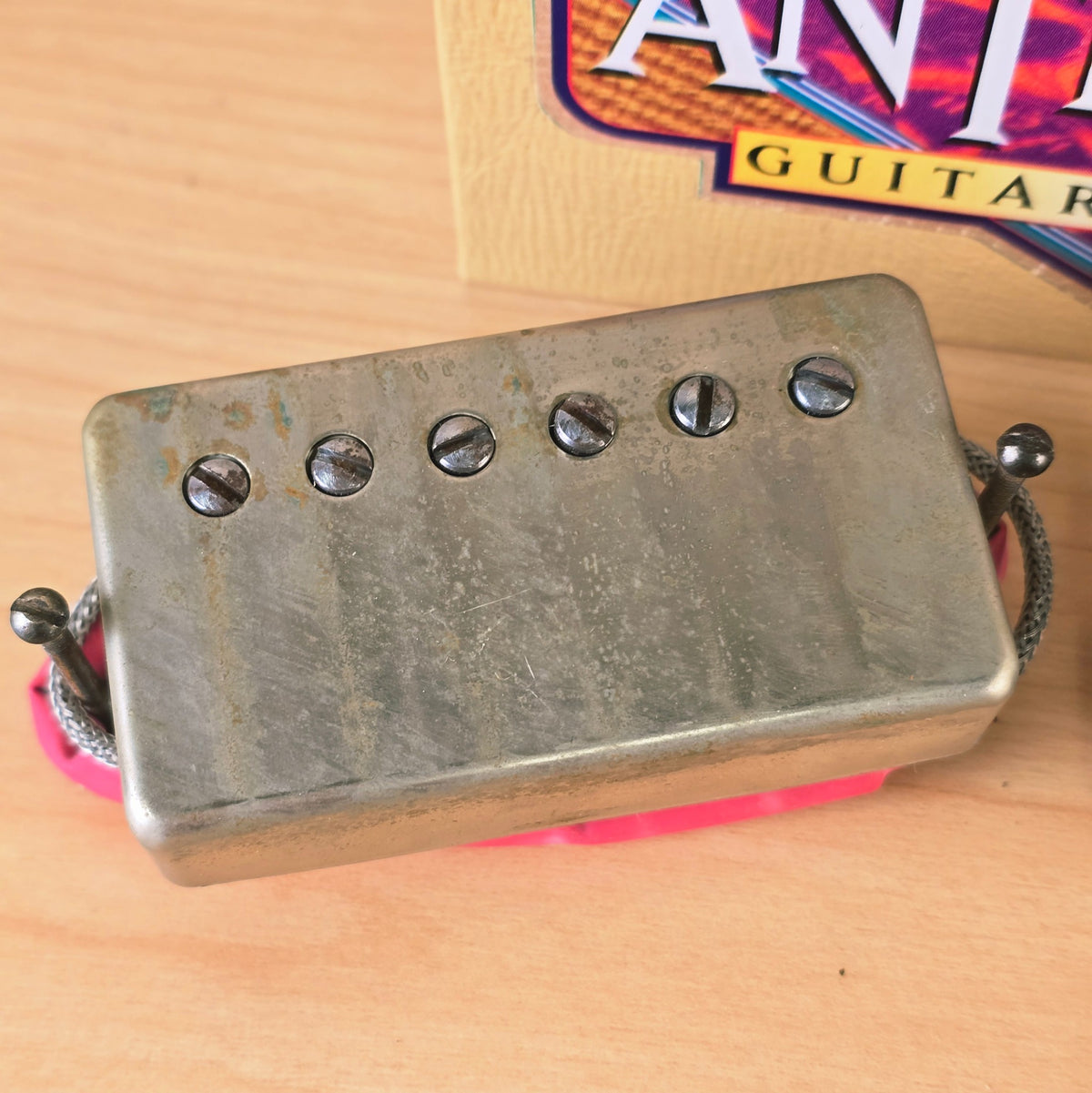 Top view of Seymour Duncan Antiquity neck humbucker pickup with aged nickel cover