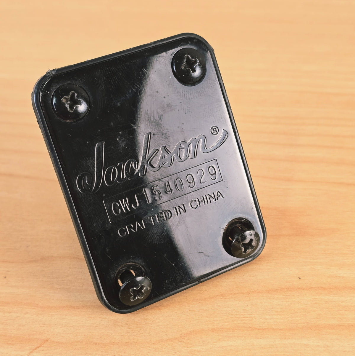 Jackson neck plate propped upright with two screws partially installed