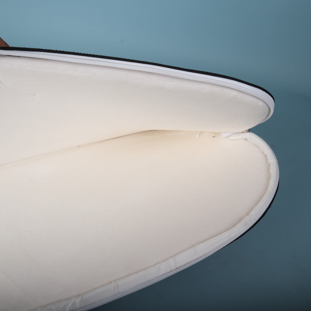 Close-up of the opened lower section showing the clean white fleece padding.