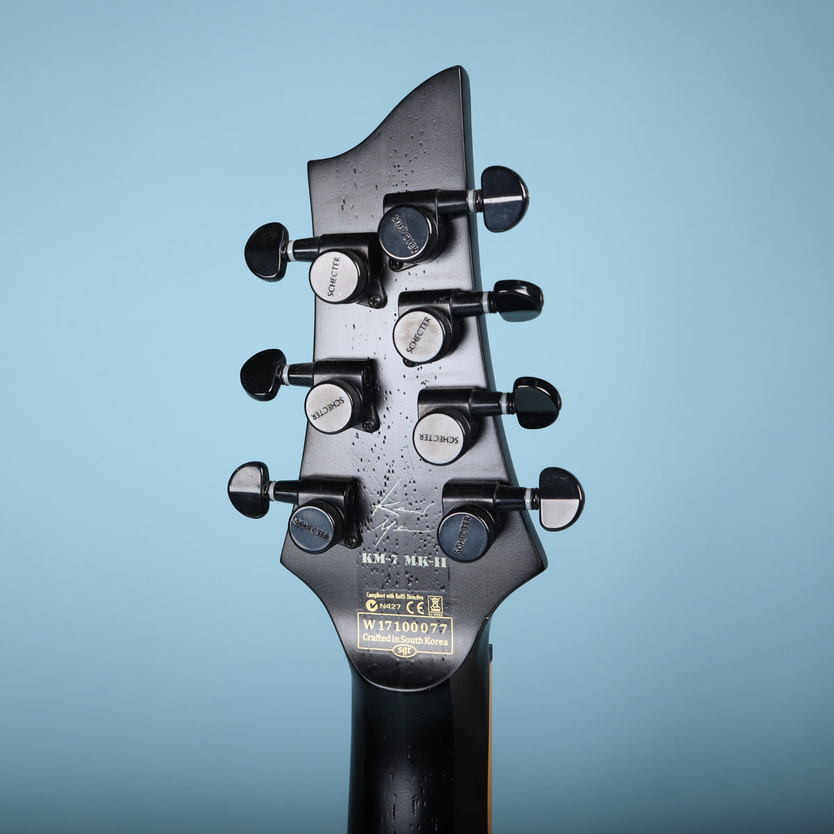 Rear of the headstock showing Keith Merrow logo, KM-7 MK-II designation, serial number, and locking tuners