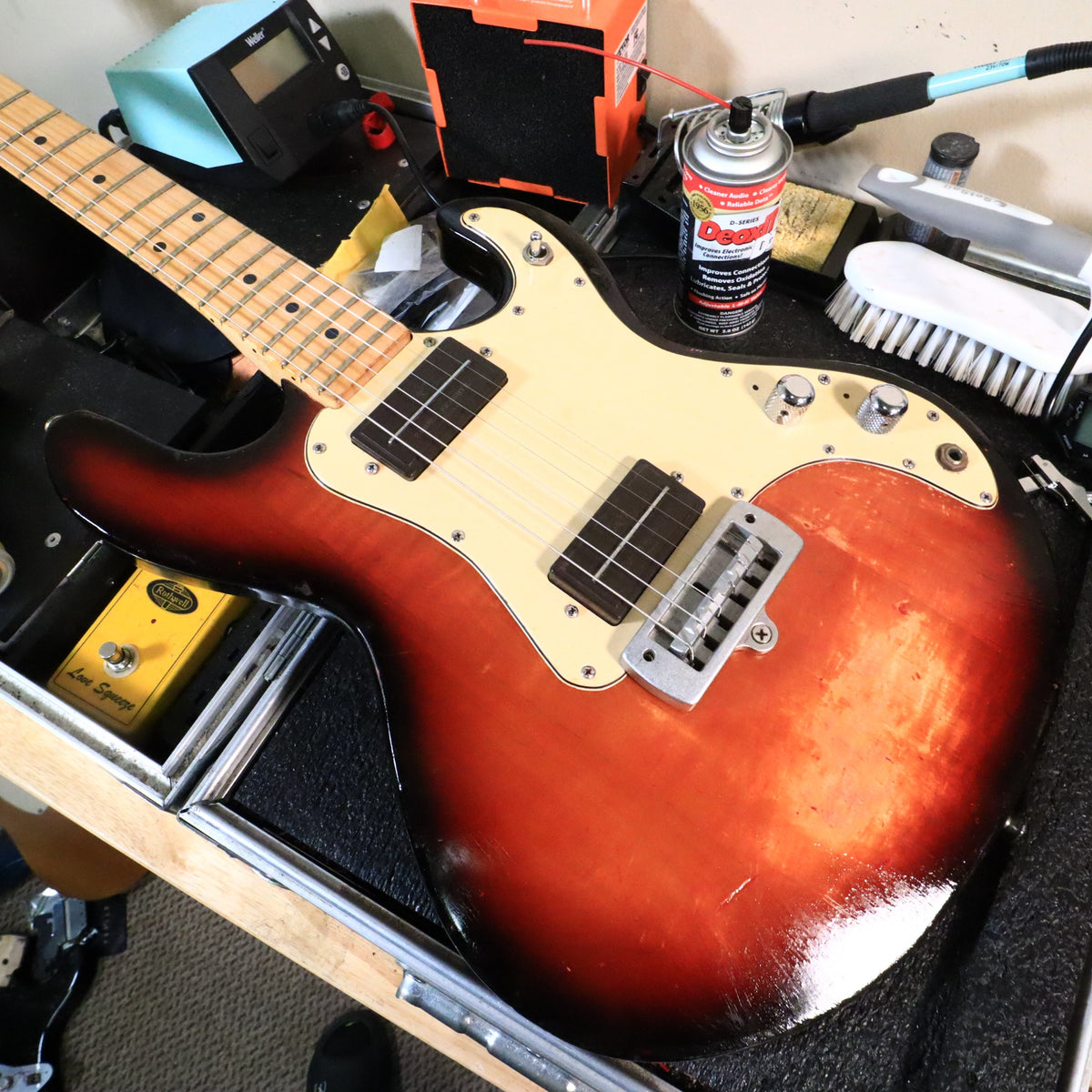 Peavey T-15 guitar body resting flat on a technician bench.