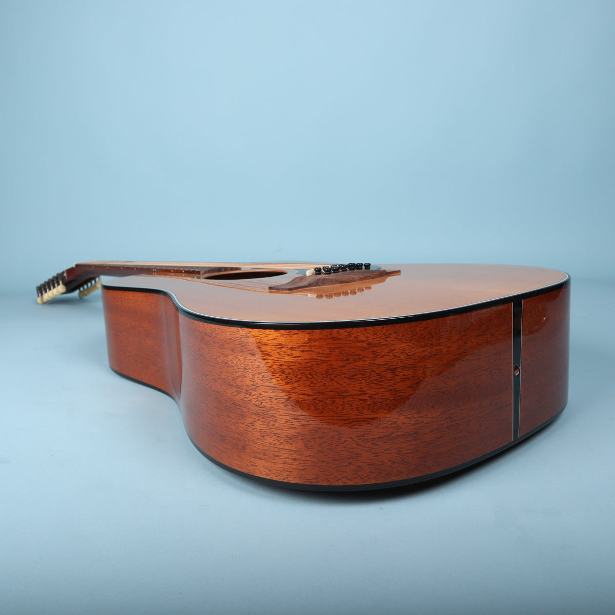 Endpin and lower bout side view of guitar body