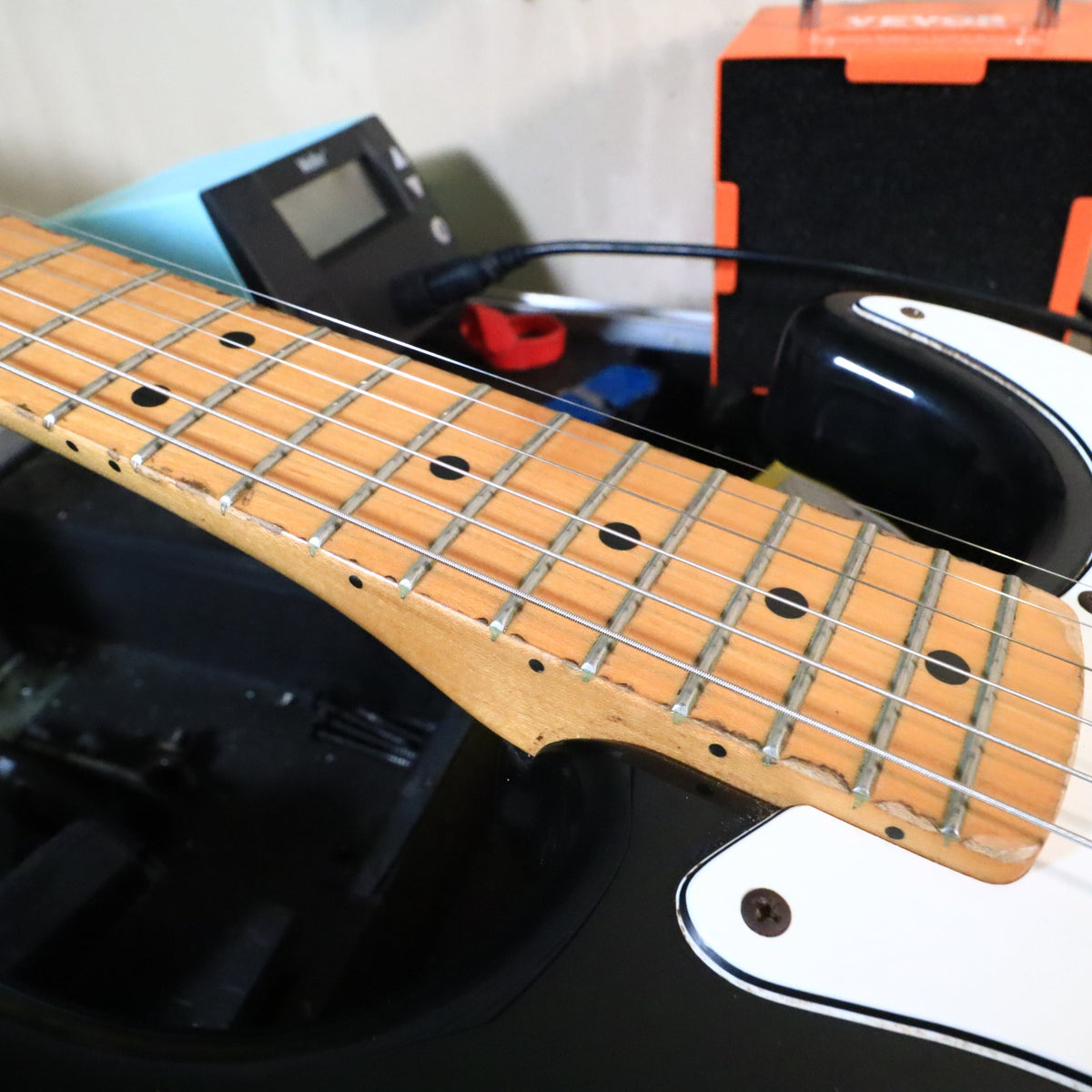 Side perspective of the upper neck and frets