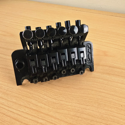 Front-angled view highlighting the string saddles and fine-tuning thumbscrews.