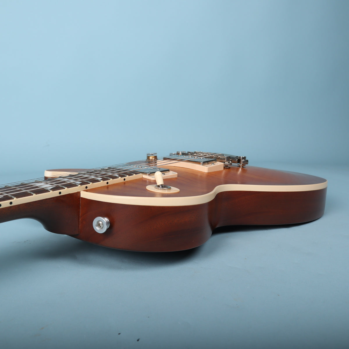 Upper body edge profile showing toggle switch and neck joint
