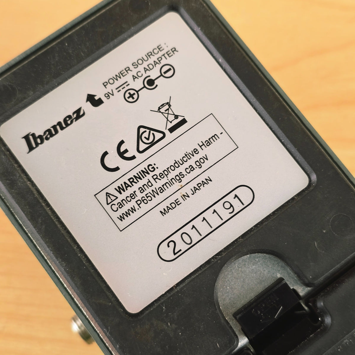 Close-up of the back label on the Ibanez TS9 displaying serial number 2011191 and Made in Japan text.