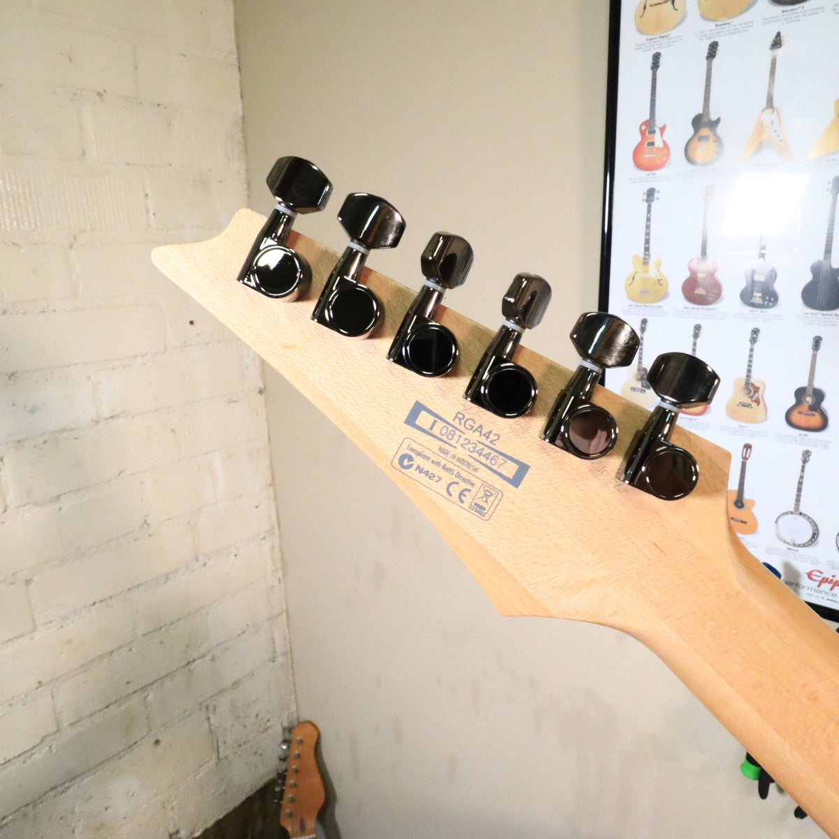 Closeup view of back of headstock showing tuner buttons and label details