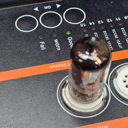 Mullard 12AX7A tube inserted in tube tester showing green Good status indicator lit.
