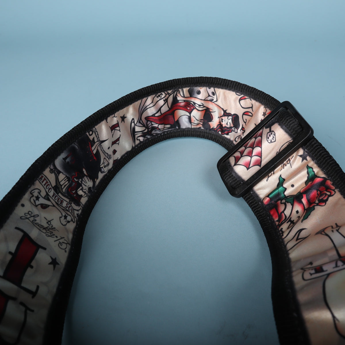 Detail of the strap curve showing the plastic length adjustment buckle and flash graphics